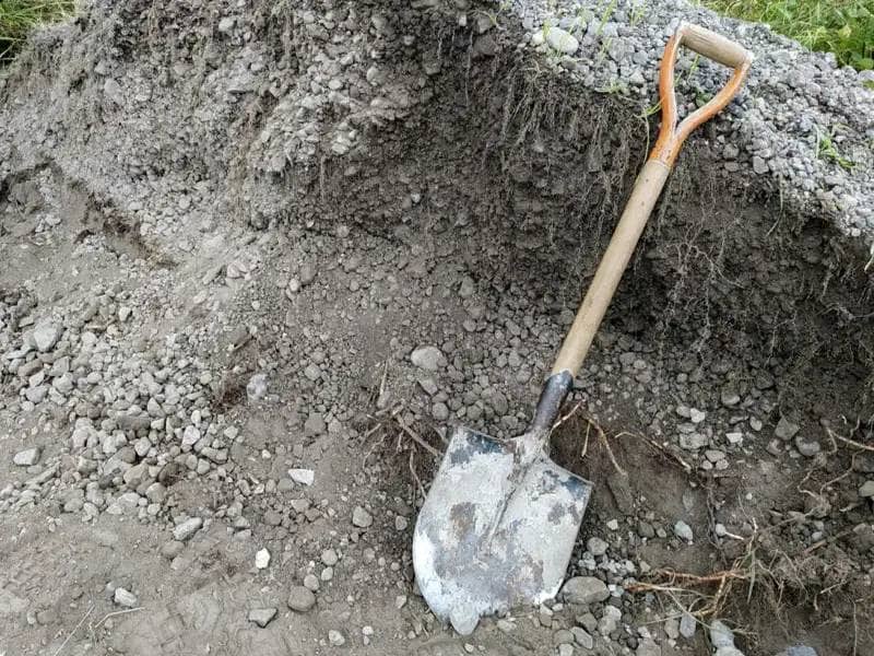 Shovel in dirt with gravel